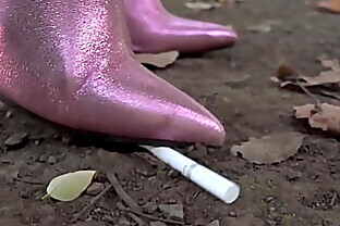 Crush by trampling a cigarette with long boots