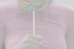 Cute teen in a skirt sucks a lollipop