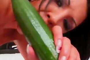 Busty babe with a big green cucumber