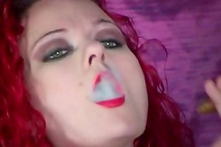 Redhead Melissa smokes a cigar while teasing us
